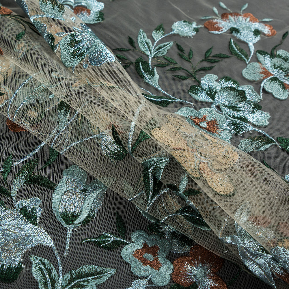 Metallic Whispering Blue, Greener Pastures and Sierra Floral Embroidered Lace on a Nude Netting Folded Metallic Whispering Blue, Greener Pastures and Sierra Floral Embroidered Lace on a Nude Netting Folded