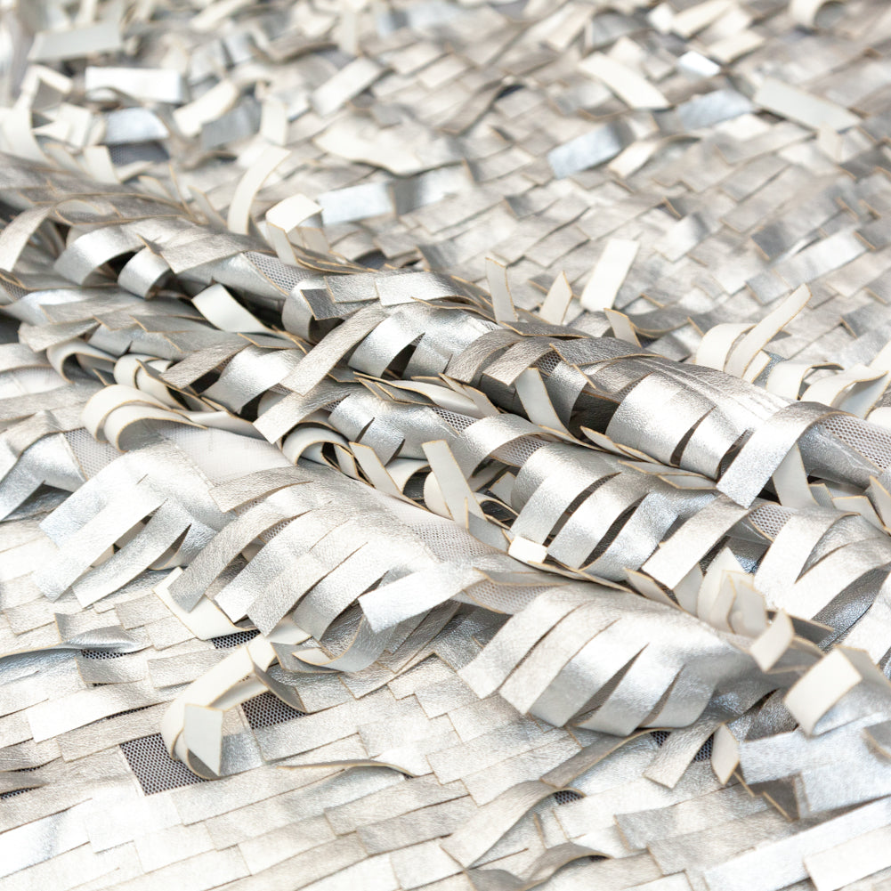 Faux Leather Fringe Fabric on a Mesh Backing - Metallic Silver on White Folded Faux Leather Fringe Fabric on a Mesh Backing - Metallic Silver on White Folded