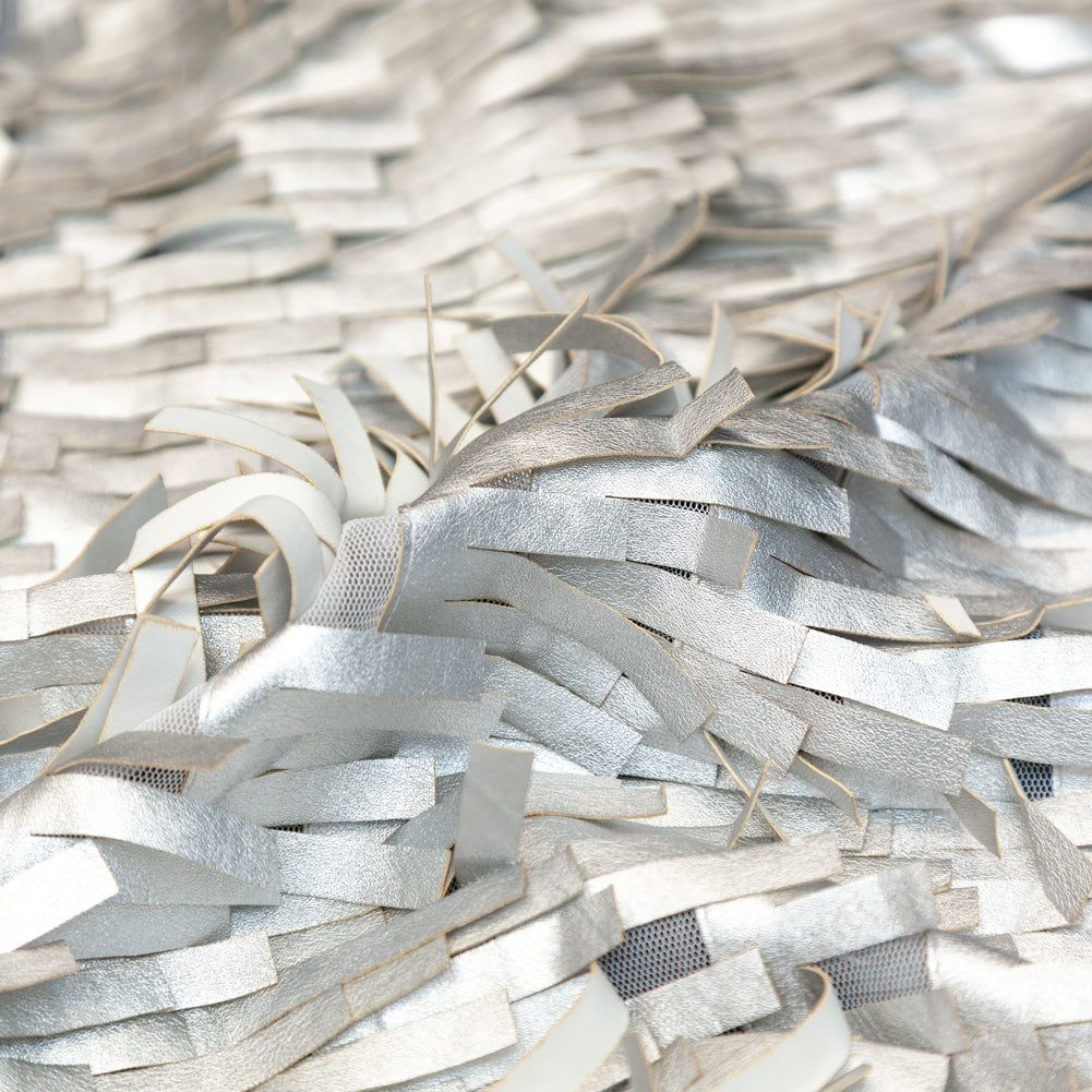 Faux Leather Fringe Fabric on a Mesh Backing - Metallic Silver on White Detail Faux Leather Fringe Fabric on a Mesh Backing - Metallic Silver on White Detail
