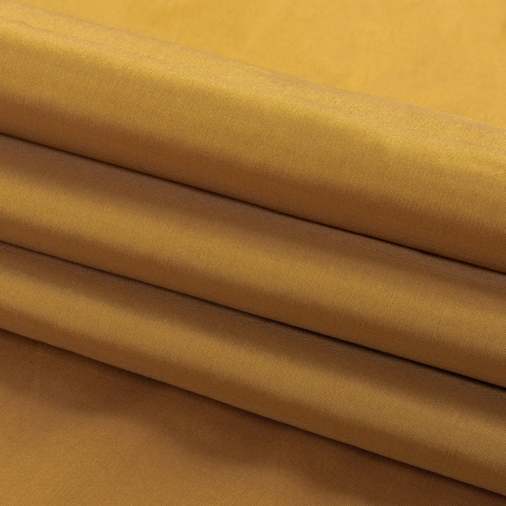 Tafetán de poliéster - Liso teñido en oro victoriano - Colección Bellamy Tafetán de poliéster - Liso teñido en oro victoriano - Colección Bellamy