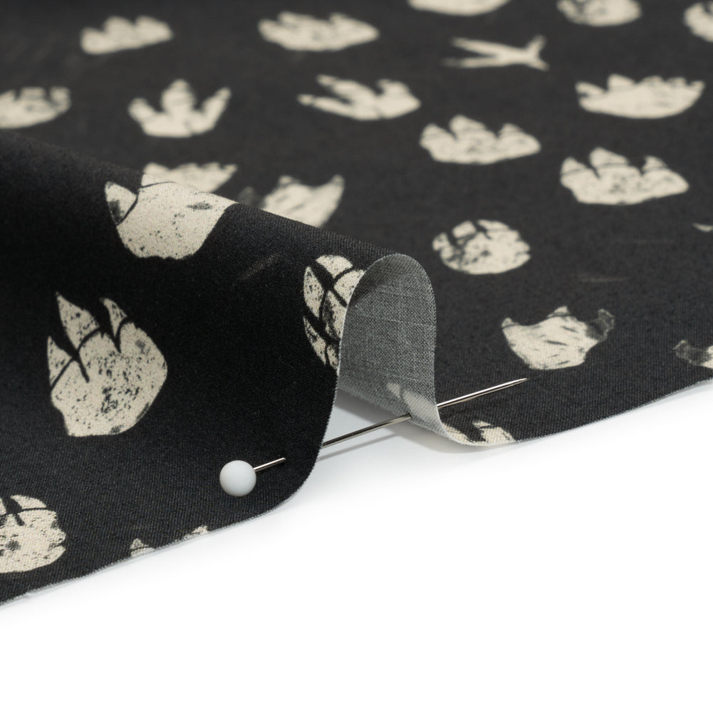 Stretch Cotton Poplin Print - Black Dinosaur Footprints - Mood Exclusive Jurassic Jubilee Detail Stretch Cotton Poplin Print - Black Dinosaur Footprints - Mood Exclusive Jurassic Jubilee Detail