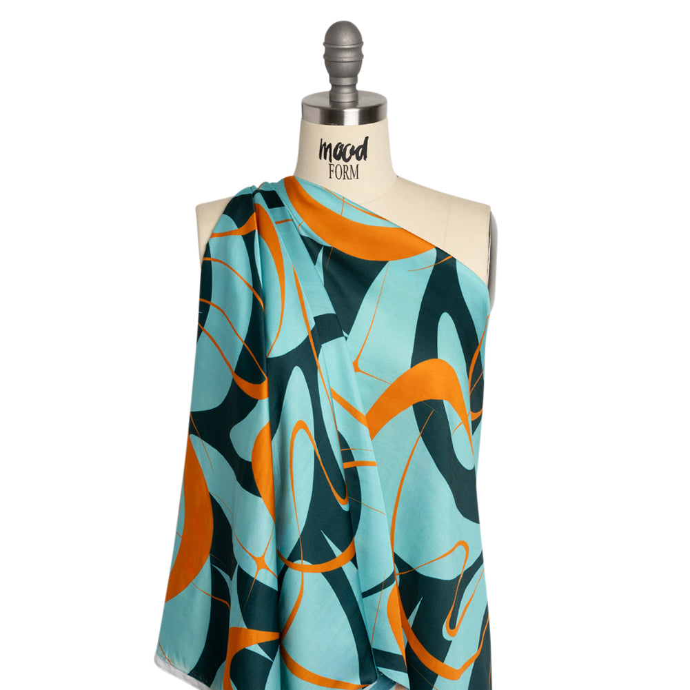 Sustainable and Recycled Viscose Satin Print - Turquoise and Orange Swirling Abstract - Mood Exclusive Atmospheric Adventure Detail Sustainable and Recycled Viscose Satin Print - Turquoise and Orange Swirling Abstract - Mood Exclusive Atmospheric Adventure Detail