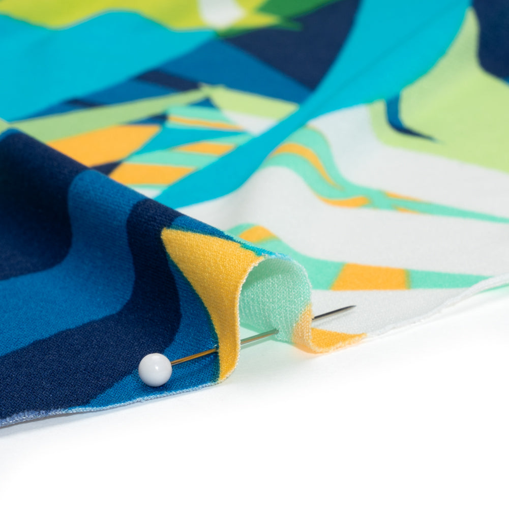 Stretch Polyester Tricot - Green, Blue and Goldenrod Overlapping Palm Leaves - Designer Deadstock Stretch Polyester Tricot - Green, Blue and Goldenrod Overlapping Palm Leaves - Designer Deadstock