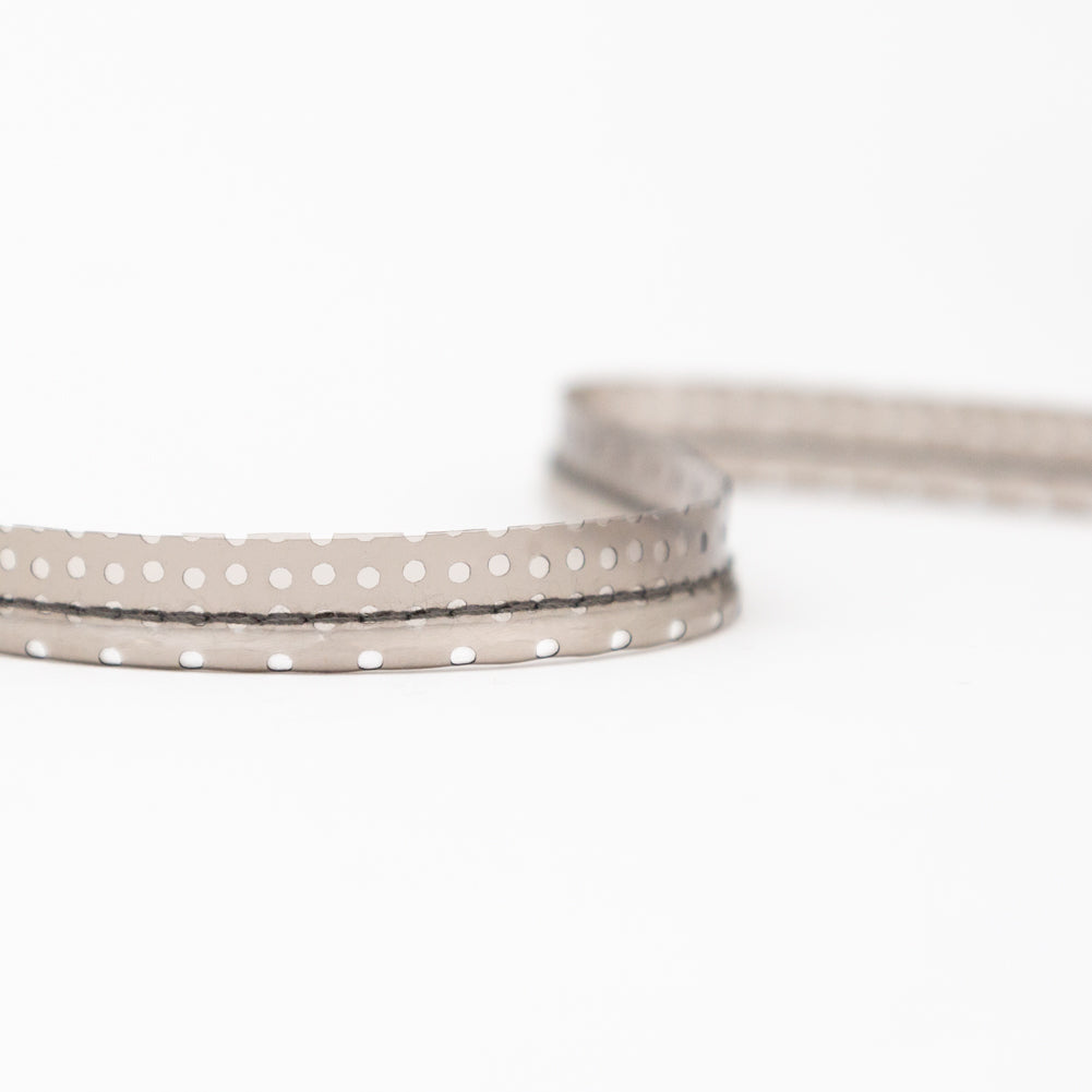 Italian White Rattail Piping with Black Perforated Plastic Casing and Lip - 0.375" Detail