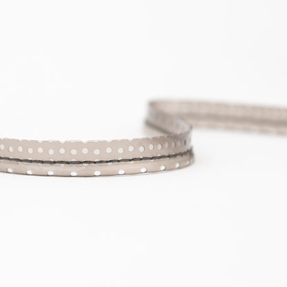 Italian White Rattail Piping with Black Perforated Plastic Casing and Lip - 0.375" Detail