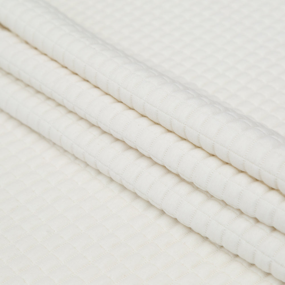 Italian Cream Quilted Rayon Knit with Filler and Polyester Knit Backing Folded