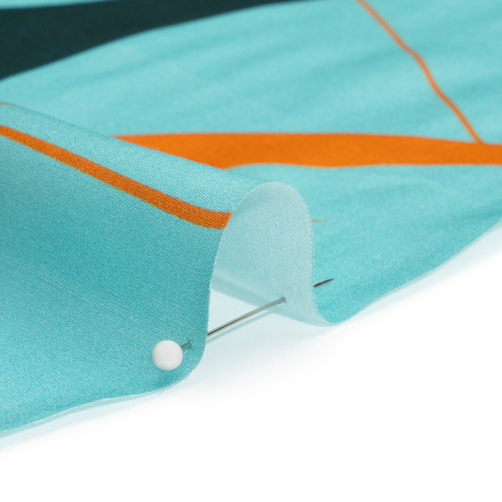 Sustainable and Recycled Viscose Satin Print - Turquoise and Orange Swirling Abstract - Mood Exclusive Atmospheric Adventure Folded