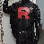 Person wearing a black outfit with a red 'R' logo, standing against a neutral background.