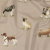British Imported Caramel Puppy Parade Printed Cotton Canvas | Mood Fabrics