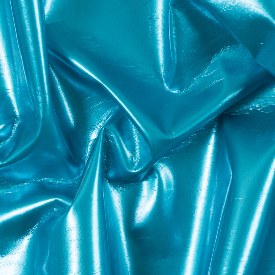 Scuba Blue Wrinkled Faux Patent Leather with a Green Fabric Backing | Mood Fabrics
