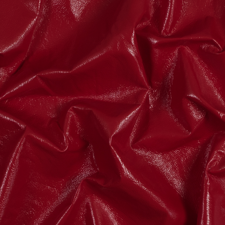Famous NYC Designer Red Faux Patent Leather with White Fleece Backing | Mood Fabrics