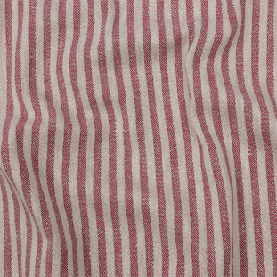 A close-up of a raspberry-colored fabric with raised stripes. This fabric is made of cotton and polyester and is available from Mood Fabrics.