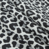 White/Black Leopard Printed Stretch Polyester Crepe - Folded | Mood Fabrics