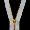 Mood Exclusive Italian Off-White and Gold T5 Open End Metal Zipper - 27.5 - Detail | Mood Fabrics