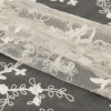 White Floral Embroidered Lace with Scalloped Edges - Folded | Mood Fabrics