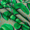 Green Leaves and Orange Geo Caye UV Protective Compression Swimwear Tricot with Aloe Vera Microcapsules - Folded | Mood Fabrics