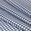 Premium Navy and White Checkered Wrinkle Resistant Dobby Cotton Shirting - Folded | Mood Fabrics