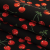 Black and Red Cherries Printed Stretch Cotton Denim - Folded | Mood Fabrics