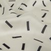 Italian Soft White and Black Sprinkles Printed Polyester Charmeuse - Detail | Mood Fabrics
