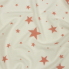 Cloud Dancer and Coral Almond Stars Stretch Polyester and Rayon French Terry | Mood Fabrics
