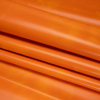 Alida Tangerine Faux Upholstery Leather with Brushed Fabric Backing - Folded | Mood Fabrics