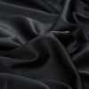 Black Stretch Polyester Satin with a Brushed Twill Backing - Detail | Mood Fabrics